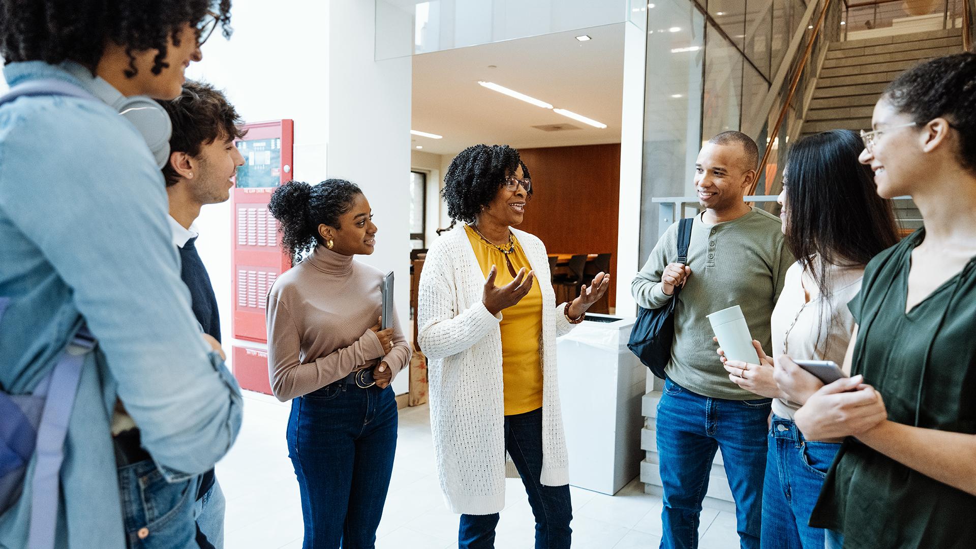 People standing in circle talking to each other